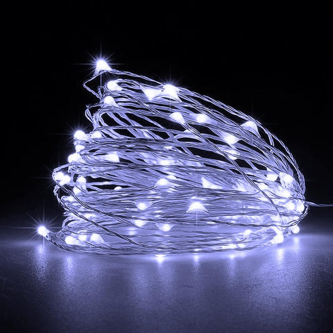 Red string lights wrapped around a Christmas tree

