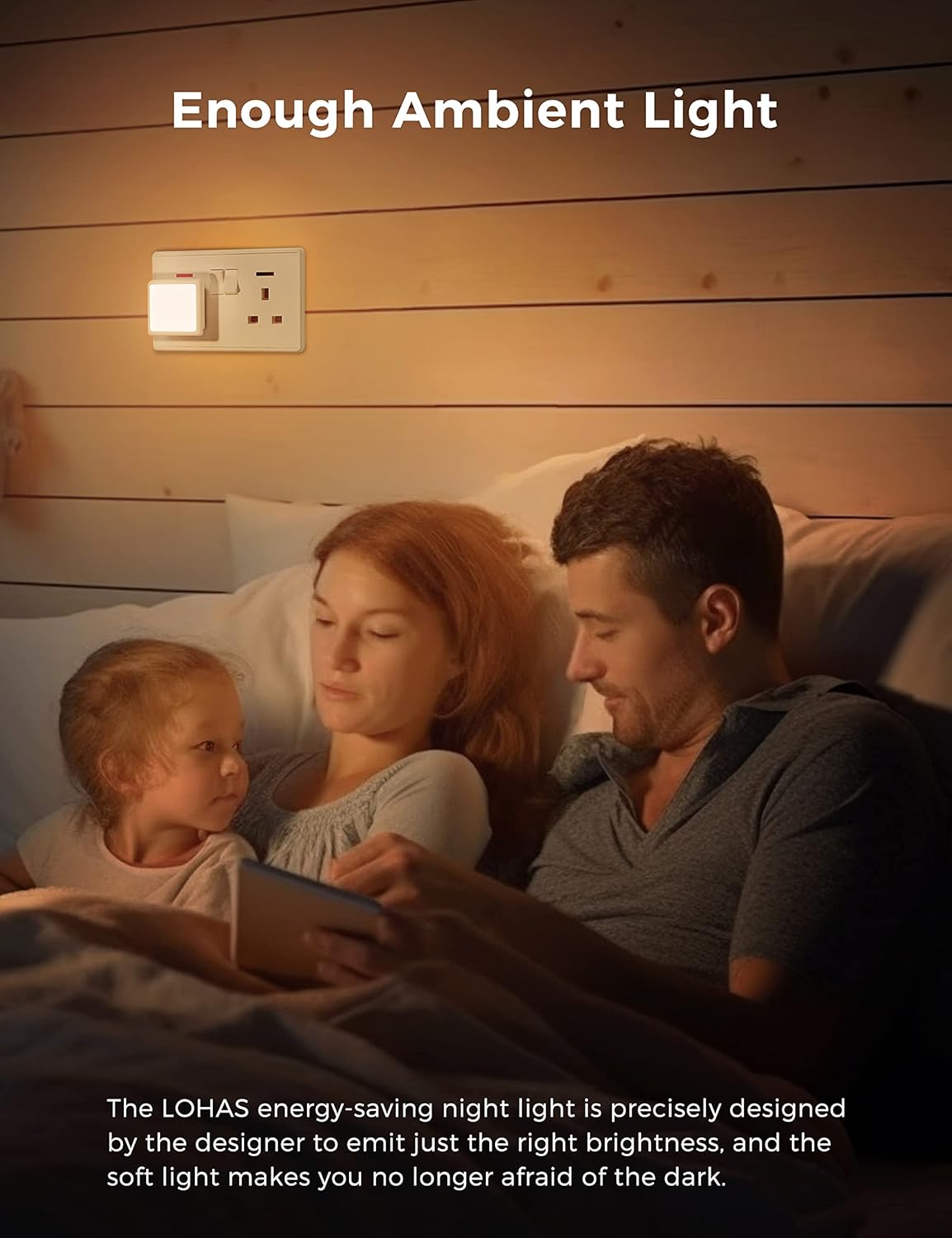 Family reading together in bed with a night light on the wall, emphasizing ambient light.