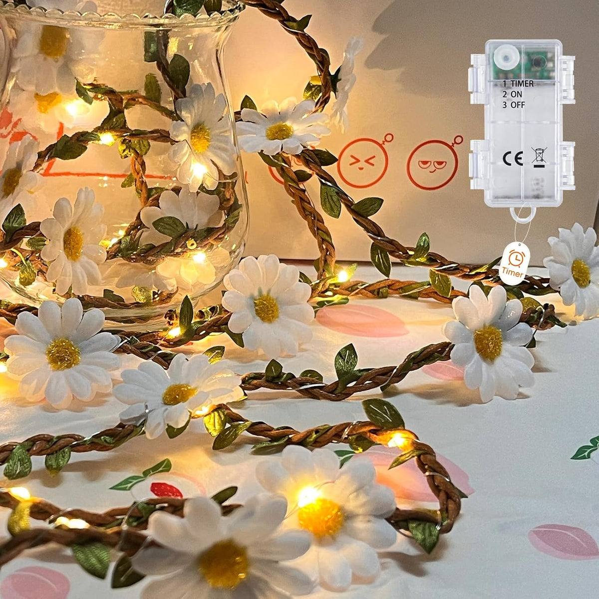 Floral string lights with a remote control on a decorative surface.