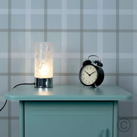 Close-up of the lamp's floral-patterned glass shade.​

