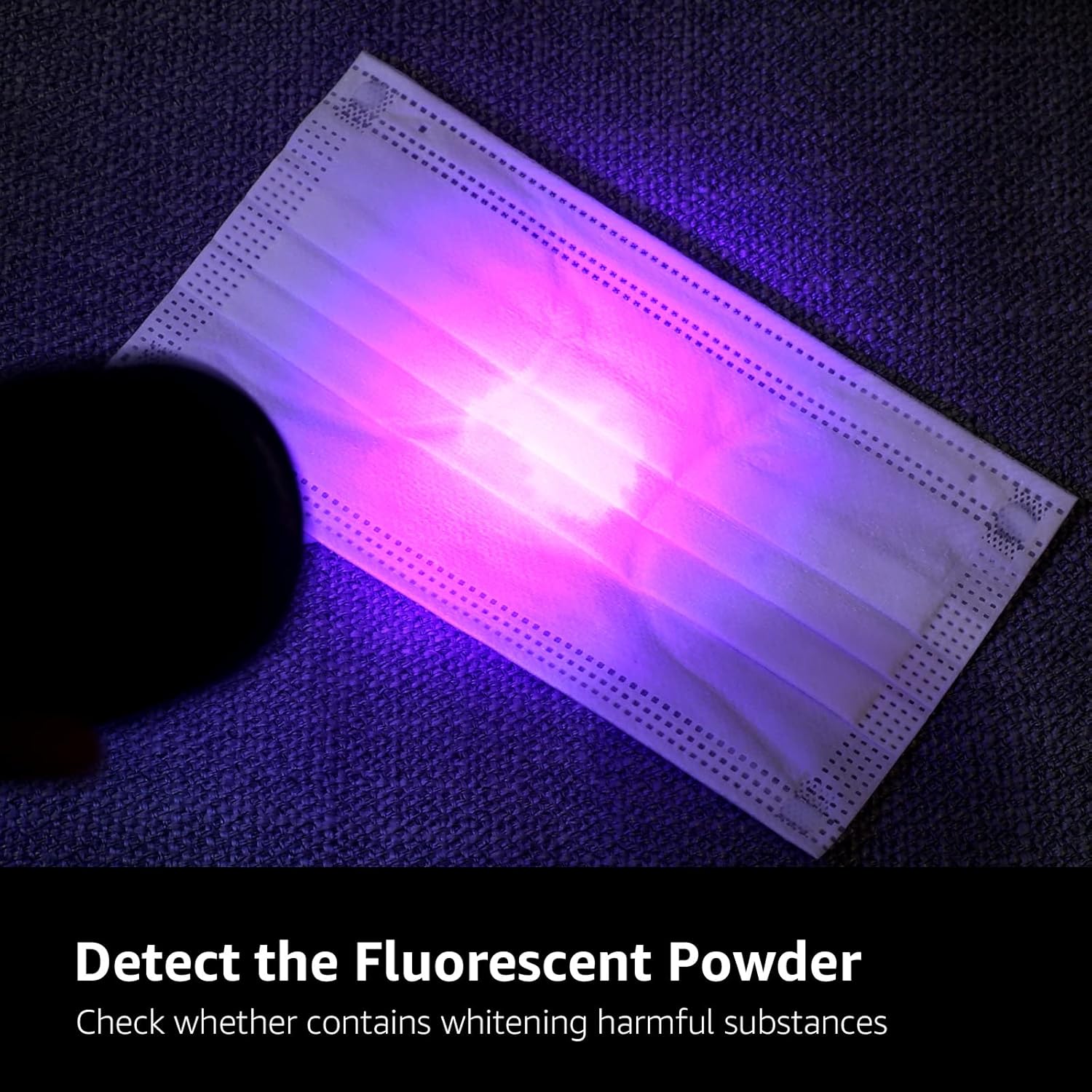 Fluorescent powder on a face mask under a UV light