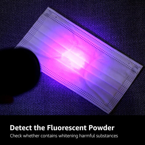 Fluorescent powder on a face mask under a UV light