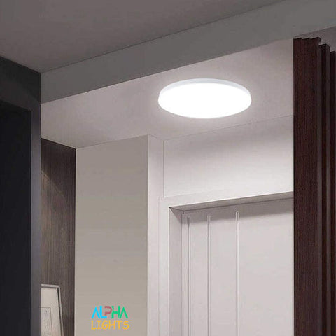 Modern flush mount LED ceiling light installed in a stylish UK bathroom

