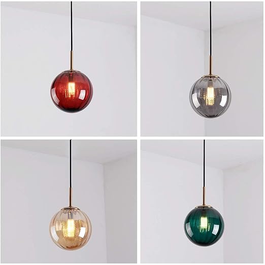 Four different colored glass pendant lights on a white background