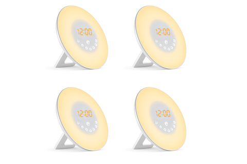 Four round alarm clocks with digital display on a white background