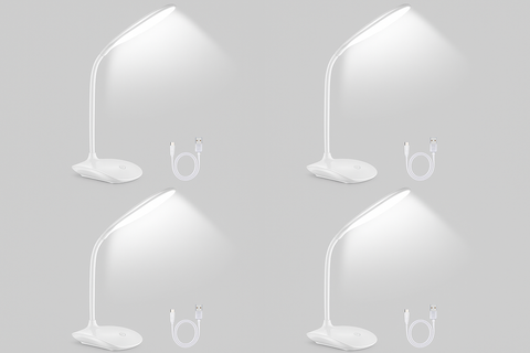 Four white desk lamps on a gray background