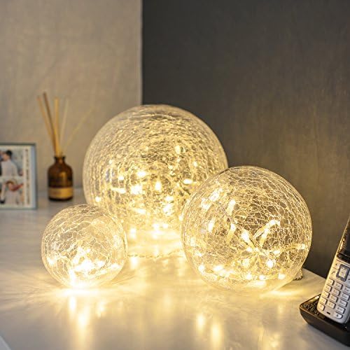 Set of 3 crackled glass fairy light orbs illuminated on a table

 