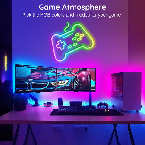 Gaming setup with RGB lighting and a neon controller icon on a screen.