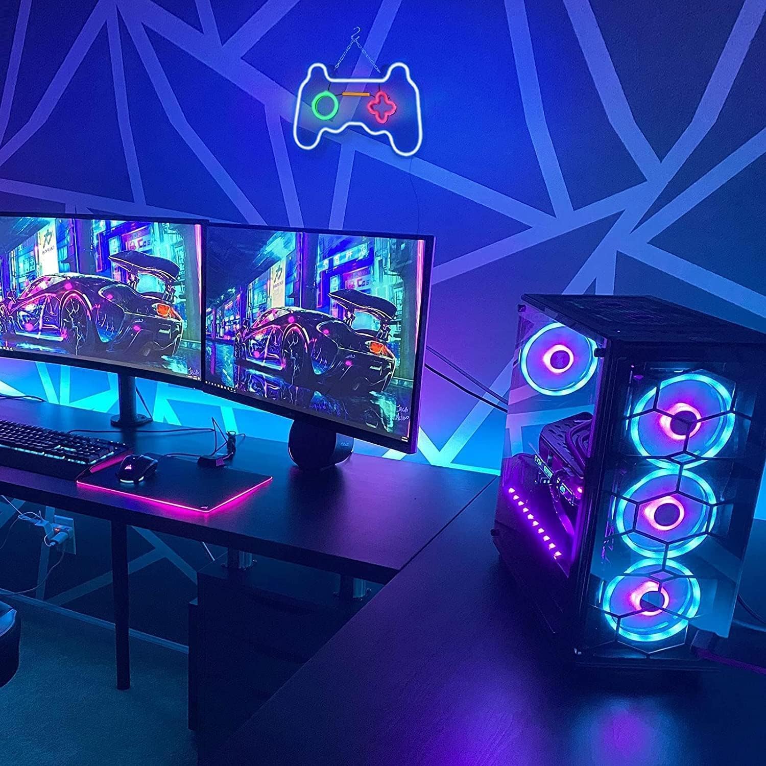 Gaming setup with dual monitors, keyboard, mouse, and RGB LED computer case.