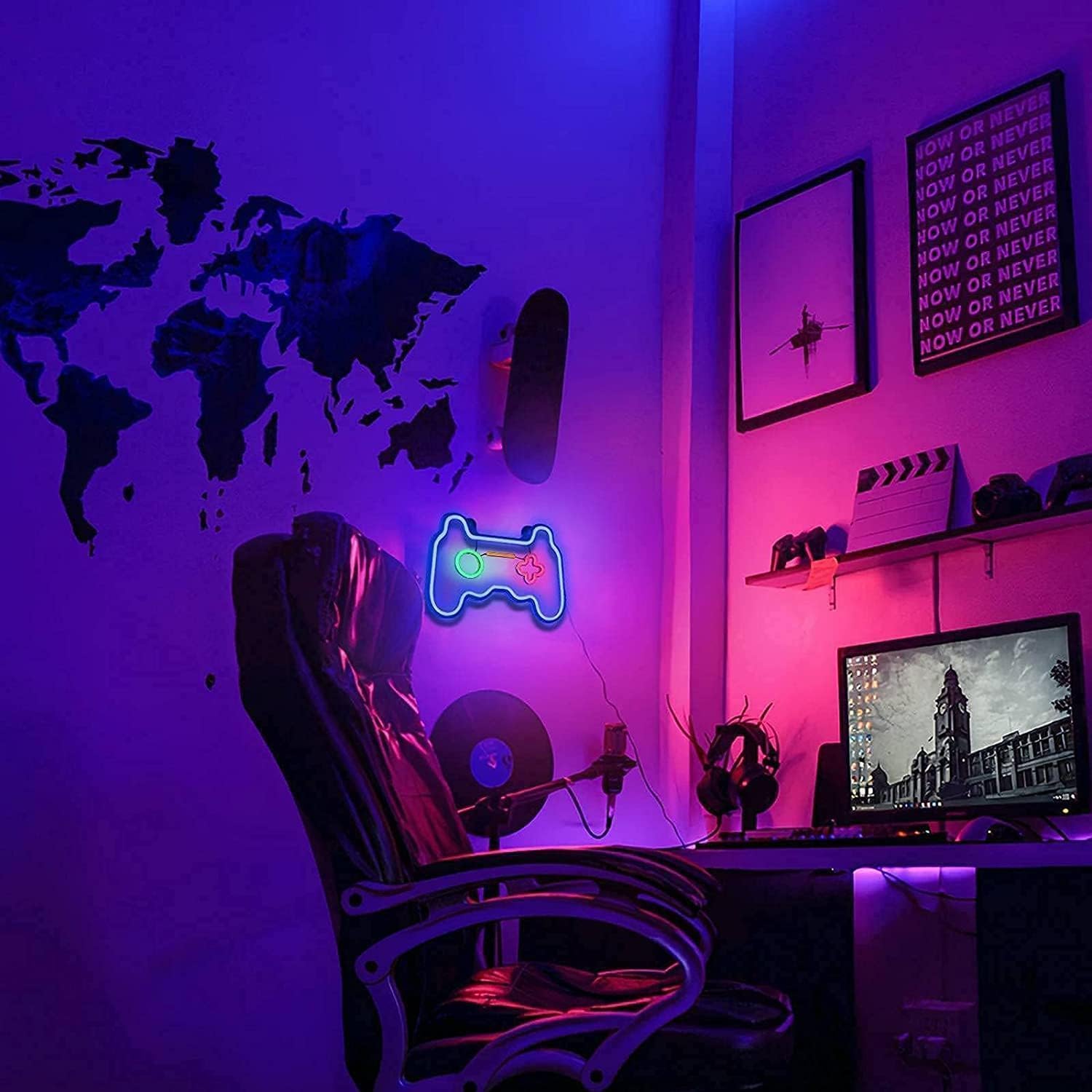 Gaming setup with neon light, world map, and computer monitor in a room with purple lighting.