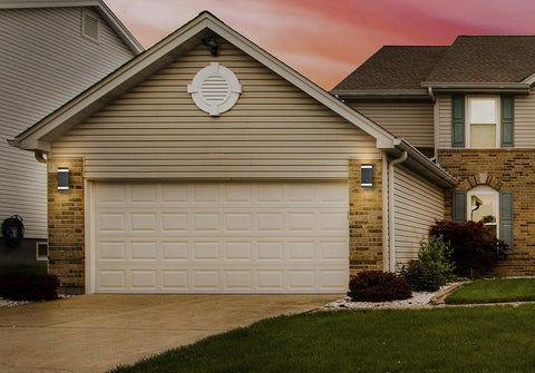Garage door of a residential house with a sunset sky