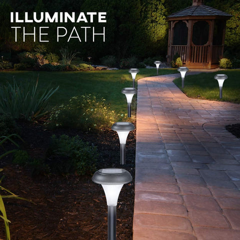 Garden pathway illuminated by solar lights with a gazebo in the background.