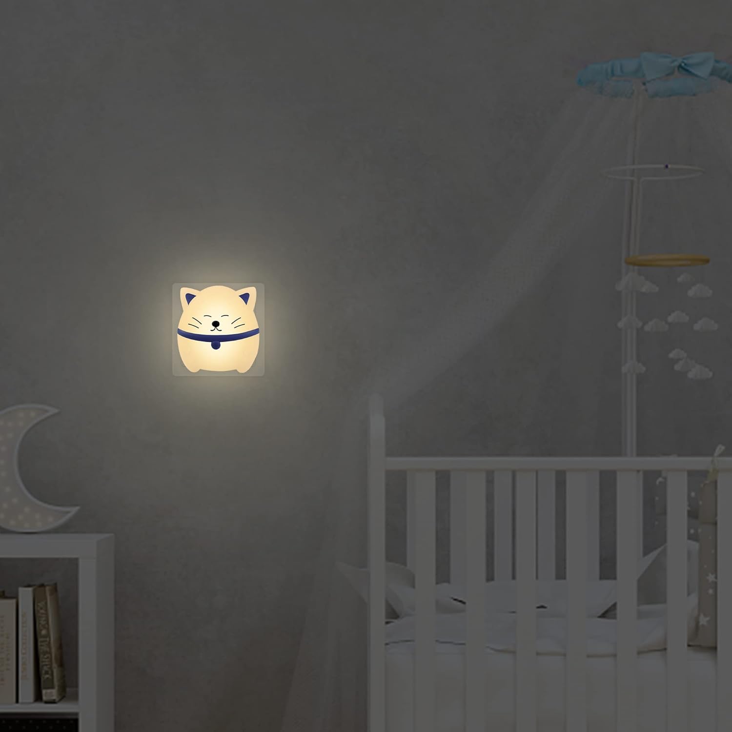 Glowing cat-shaped night light on a dark wall in a child's bedroom.