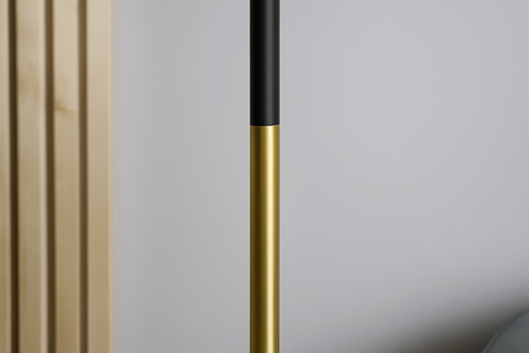 Gold and black cylindrical object against a neutral background