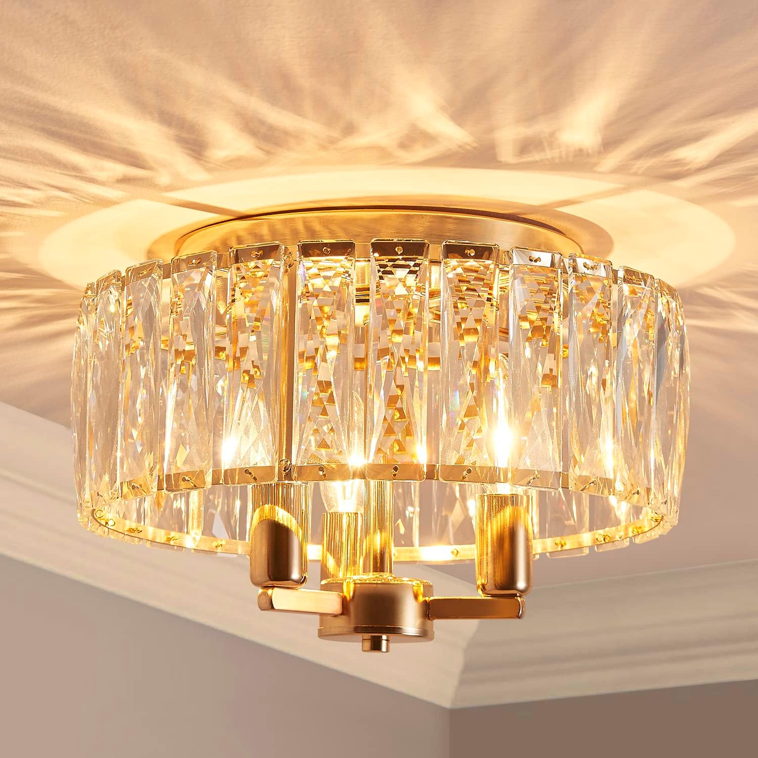 Gold and crystal ceiling light fixture on a neutral background