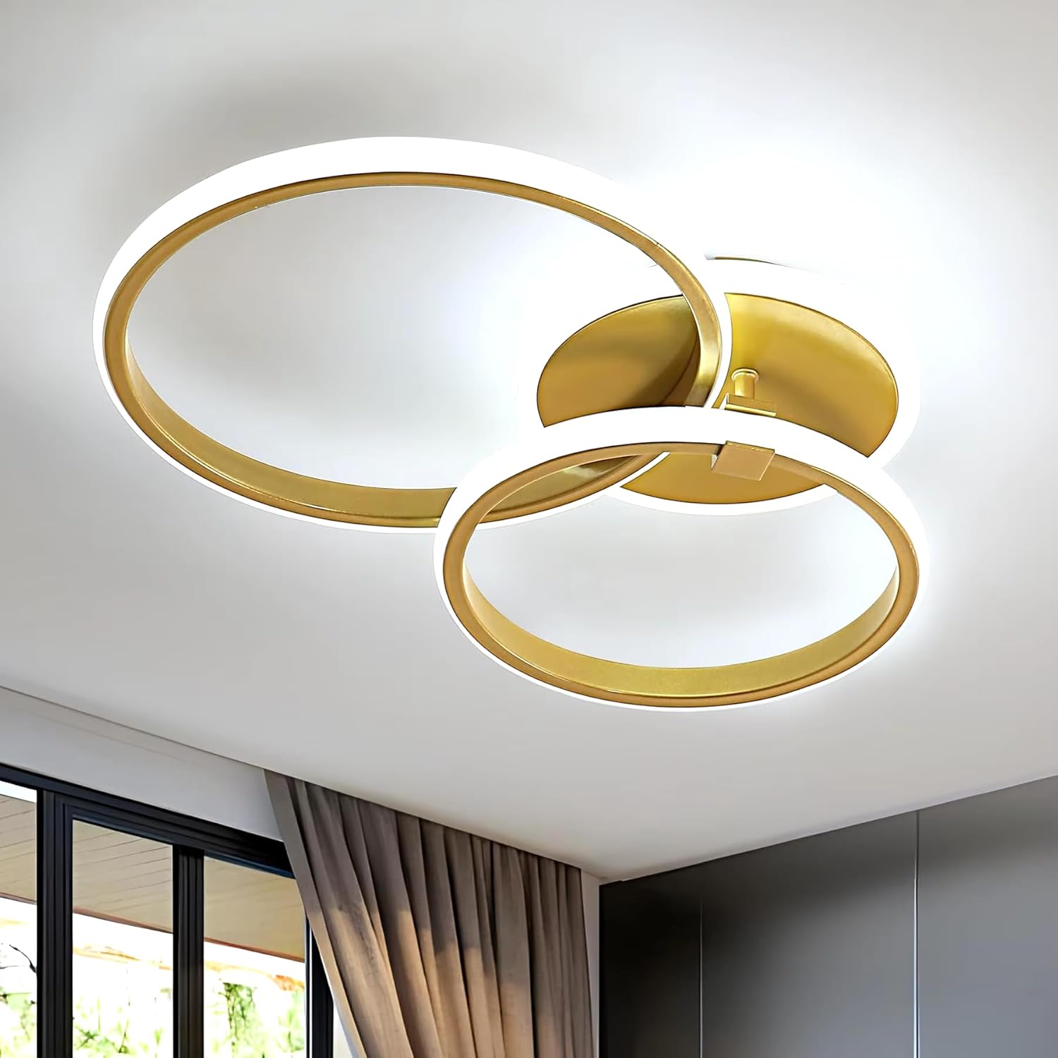 Gold circular ceiling light fixture on a white ceiling