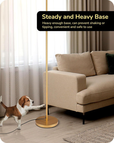 Gold floor lamp with a steady and heavy base in a living room setting.