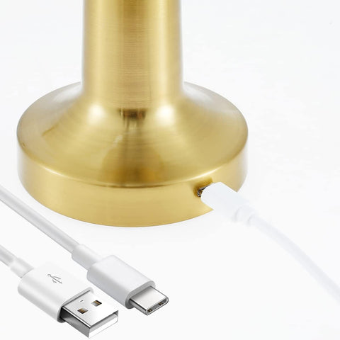 Gold lamp base with white USB cable on a white background