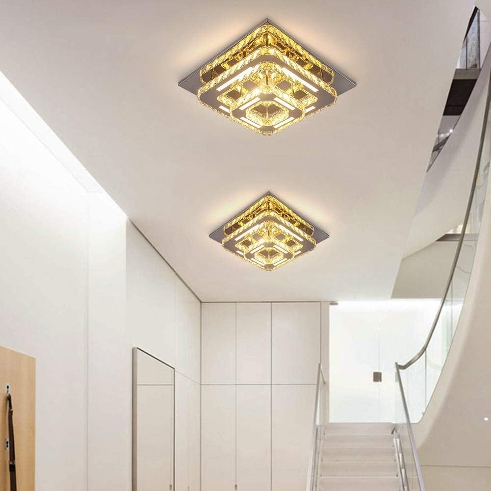 Gold square ceiling lights in a modern interior setting with stairs and white walls.