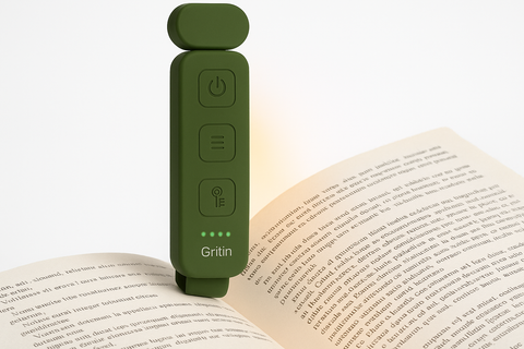 Green Gritin device on an open book with a white background