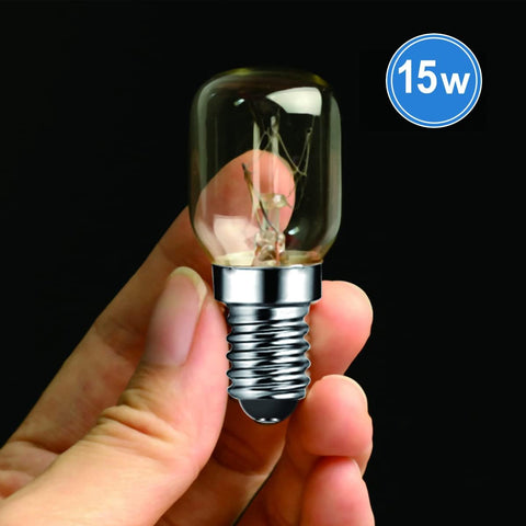 Hand holding a 15-watt light bulb with a clear glass cover against a black background.