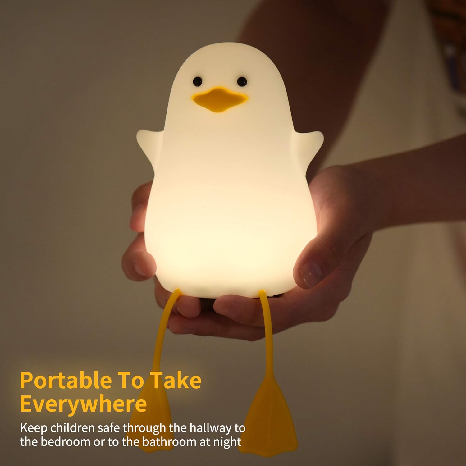 Hand holding a duck-shaped night light with text about its portability.