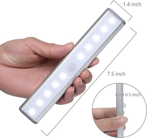Hand holding a rectangular light with dimensions labeled