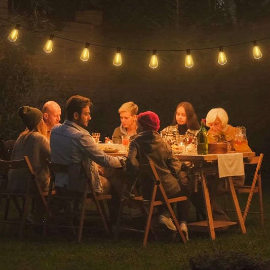 Waterproof 24FT festoon lights hanging above a outdoor family dinners celebration.

