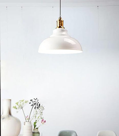 Retro iron pendant light illuminating a modern loft space

