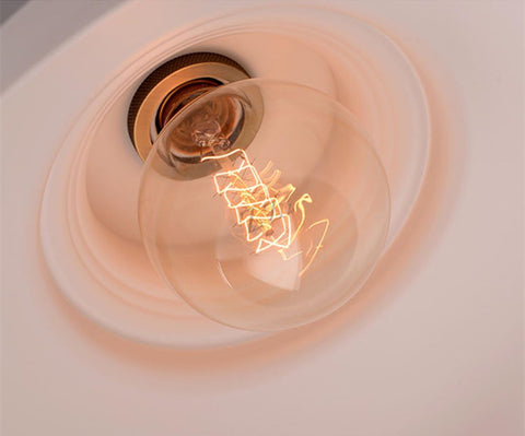 Retro iron pendant light illuminating a modern loft space

