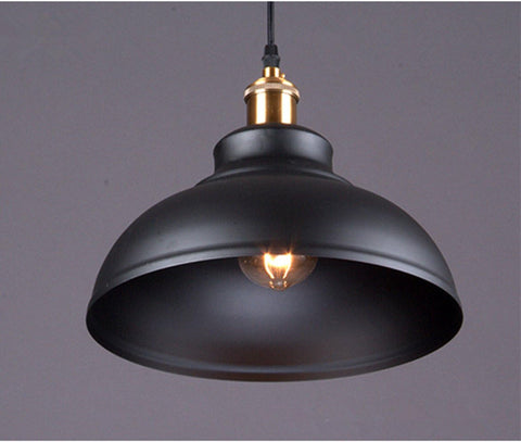 Retro iron pendant light illuminating a modern loft space

