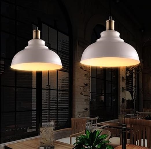 Retro iron pendant light illuminating a modern loft space

