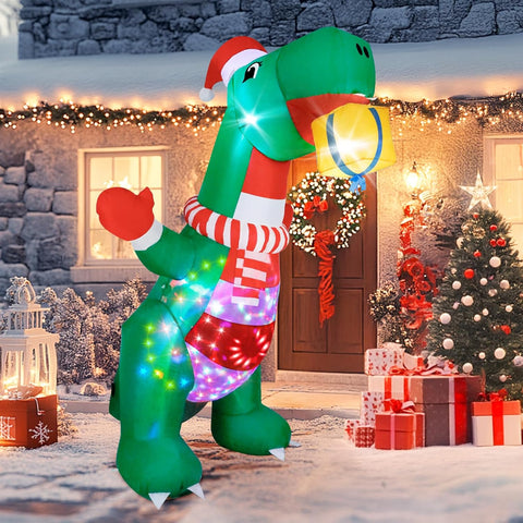 Inflatable dinosaur decoration with Christmas lights and a Santa hat in front of a decorated house.