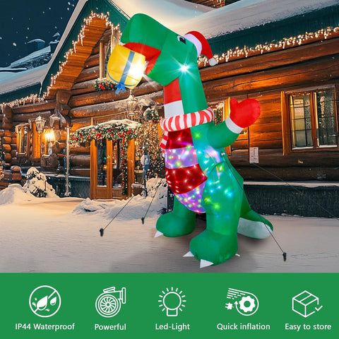 Inflatable dinosaur decoration with lights and a gift, in front of a log cabin during Christmas.
