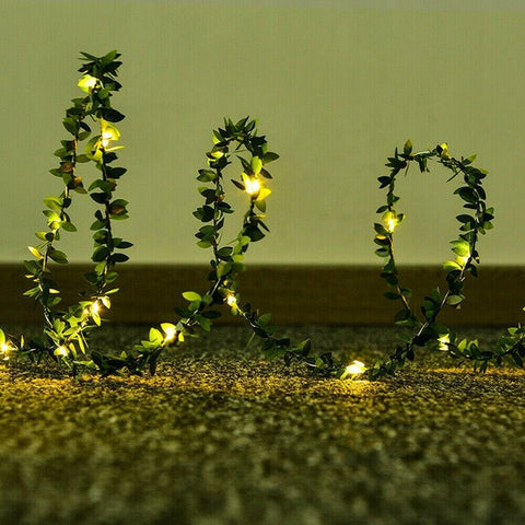 Decorative string lights shaped like a heart on a textured surface with a neutral background