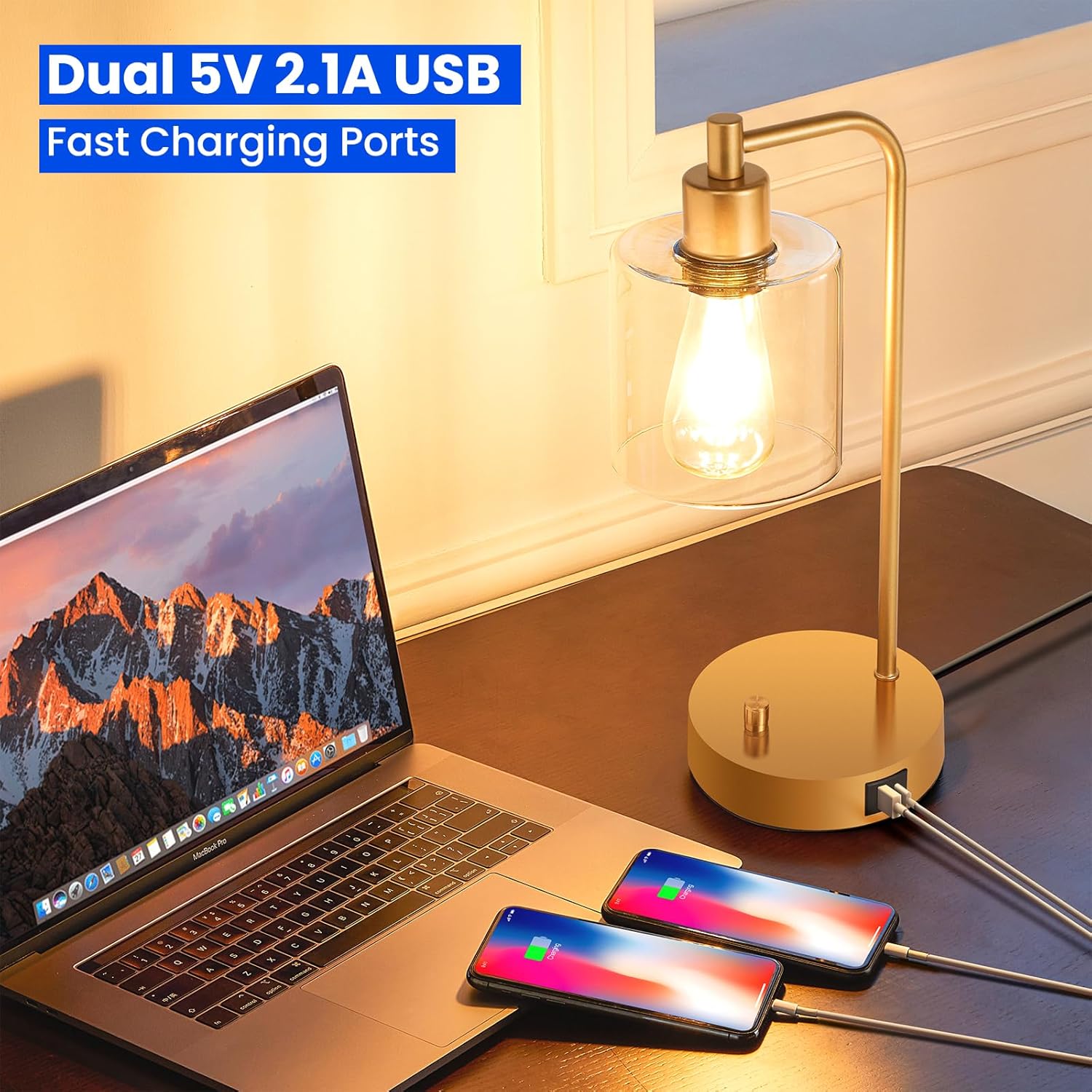 Laptop and phones charging from a gold desk lamp on a desk with 'Dual 5V 2.1A USB Fast Charging Ports' text.