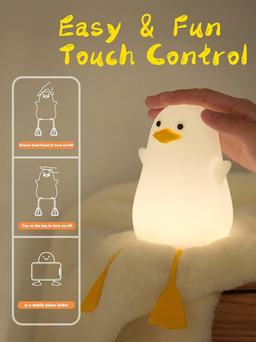Light-up duck toy with touch control features and a hand interacting with it.