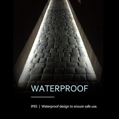 Light fixture with waterproof design text on a dark background