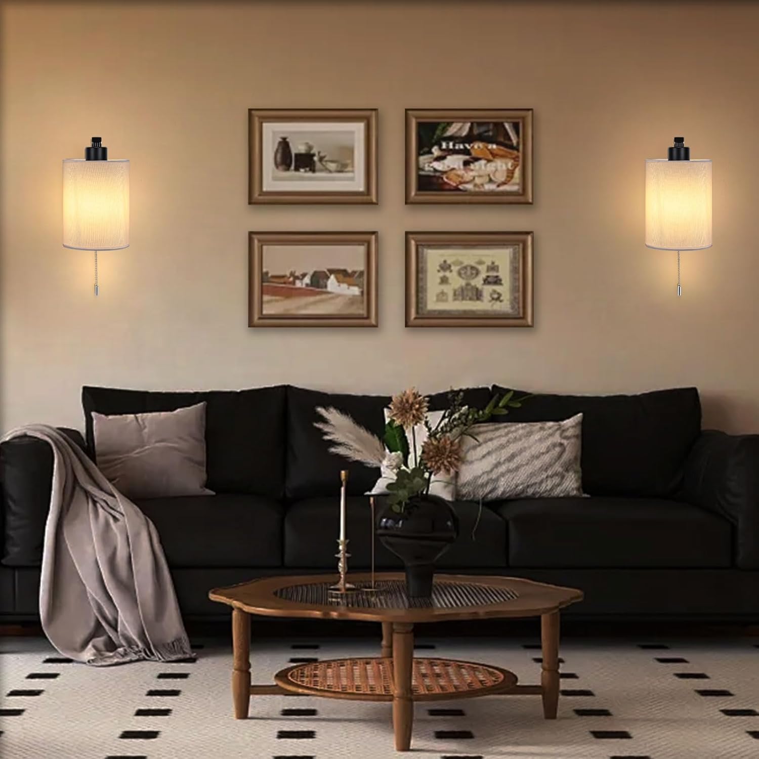 Living room with a black sofa, wooden coffee table, and framed pictures on the wall.
