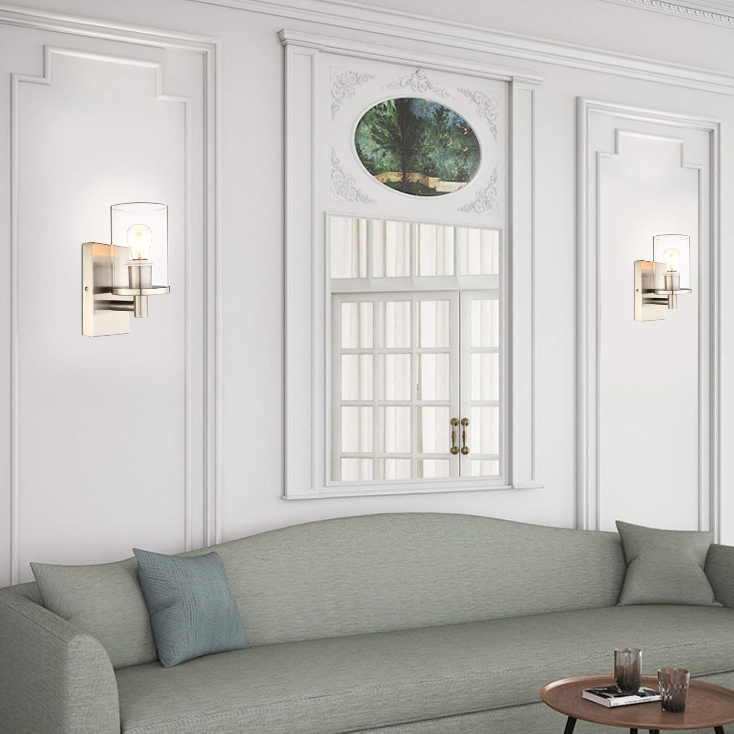 Living room with gray sofa, decorative pillows, and wall sconces.