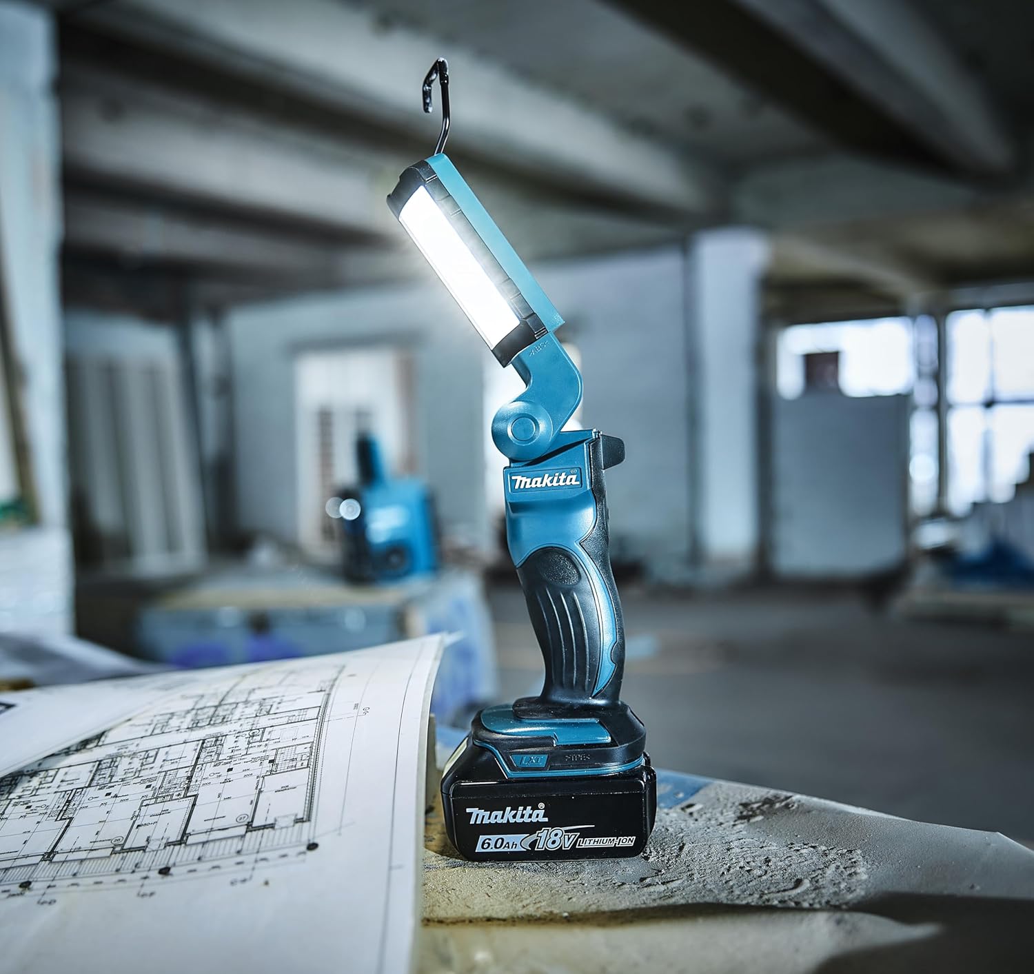 Makita work light on a blueprint in an industrial setting
