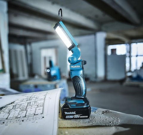 Makita work light on a blueprint in an industrial setting