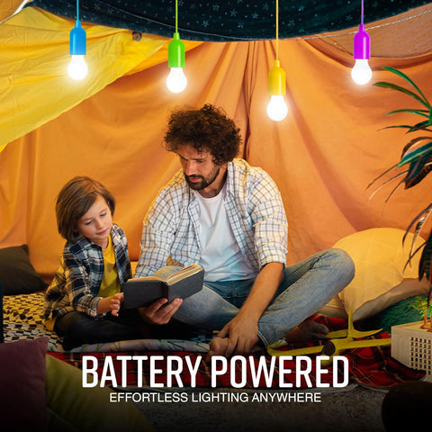 Man and child sitting inside a tent reading a book with battery-powered lights hanging from the ceiling.