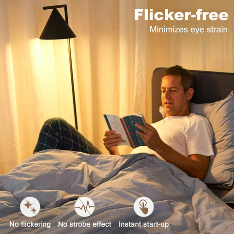 Man reading a book in bed with a lamp and 'Flicker-free' text overlay.