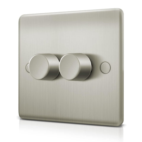 Metallic light switch with two knobs on a white background