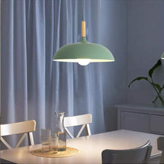 Modern industrial green pendant light hanging over a kitchen island.

