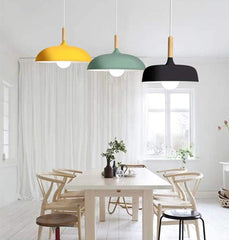 Modern industrial green pendant light hanging over a kitchen island.

