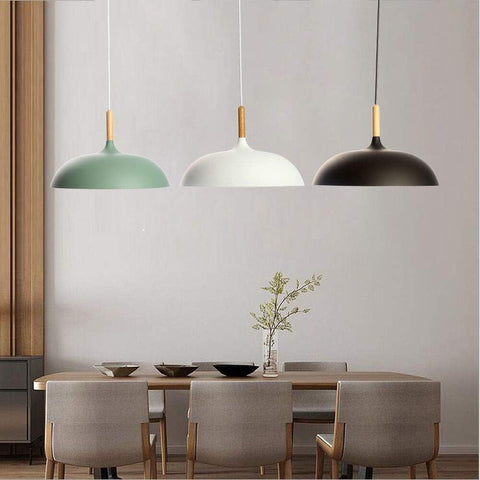 Industrial pendant light fixture in a contemporary bar setting.

