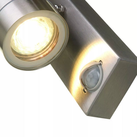Stainless steel wall light enhancing the security of a home's entrance


