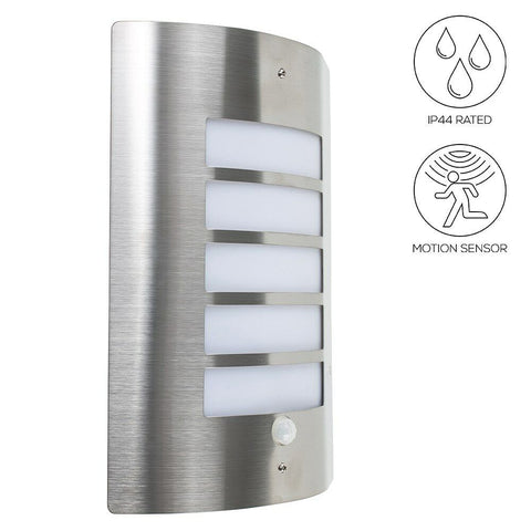 LED wall light with motion sensor illuminating a backyard pathway at night

